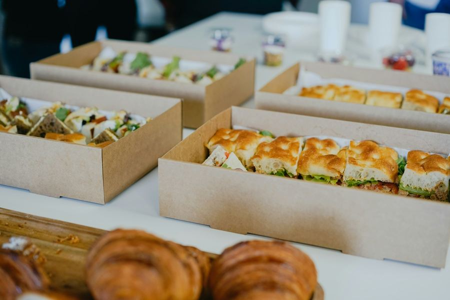 Boxed sandwiches and rolls laid out ready for distribution as lunch packs
