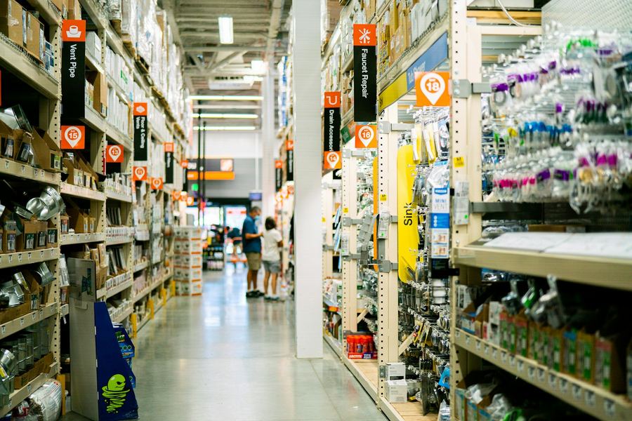 A long aisle of shelved hardware and consumable supplies