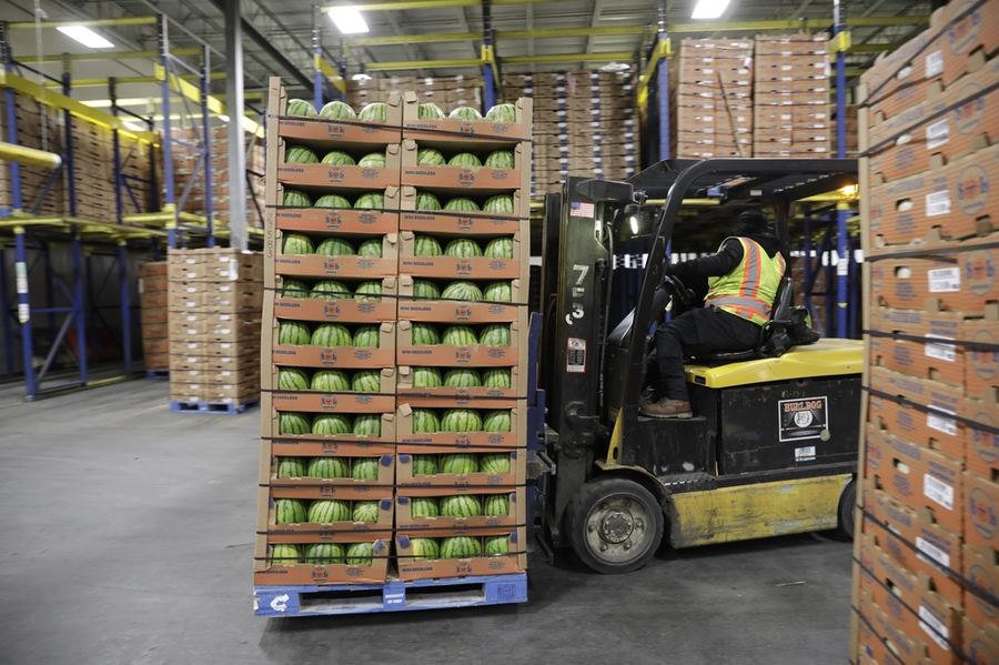 Pallets of stock stacked on racking inside a distribution warehouse